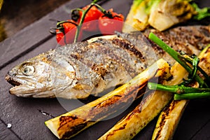 Rainbow trout grilled. Vegetables, white wine sauce. Delicious healthy traditional food closeup served for lunch in