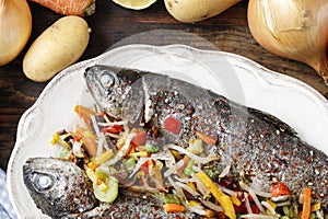 Rainbow trouts with cut vegetables