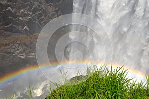 Rainbow at Victoria Falls, the largest waterfall in Africa, on the border of Zambia and Zimbabwe, photographed on the edge of the