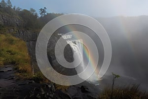 Rainbow That Is Visible Only As Faint, Ephemeral Mist Above The Waterfall. Generative AI