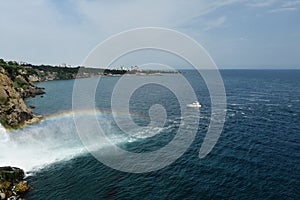 Rainbow waterfall flowing into the sea.