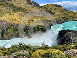 Rainbow in a waterfall in the mountains in Torres del Paine National Park in Chilean Patagonia