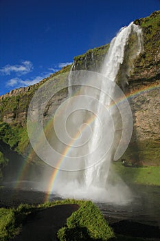 Rainbow and waterfall Seljalandsfoss in Iceland