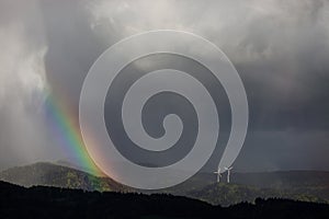 Rainbow and wind power mills in black forest