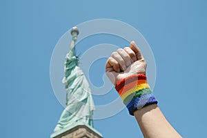 rainbow wristband in front of Statue of Liberty