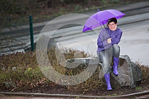 Raincoat dressed woman waiting in the rain