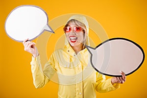 Raincoat woman yellow background. Spech bubles empty copyspace for your ad texy information
