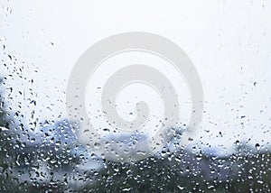 Raindrop on glass window Blur background Cloudy sky