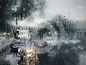 Raindrop on glass window in rainy season rain background