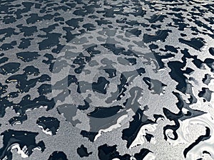 Raindrops on the black table surface that forms some abstract conceptual background