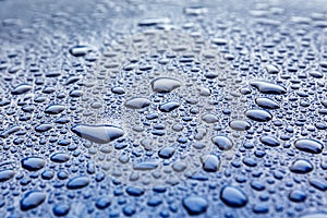 Raindrops on a blue car body with Hydrophobic Effect