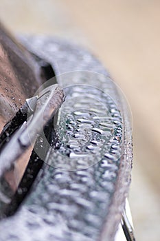 Raindrops on the car. Car element with raindrops close-up. Car r