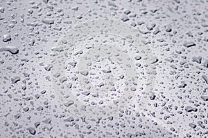 Raindrops on the car. Car element with raindrops close-up. Doors and door handle and glass of a black car in raindrops. Big