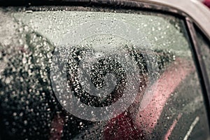 Raindrops on the car glass.