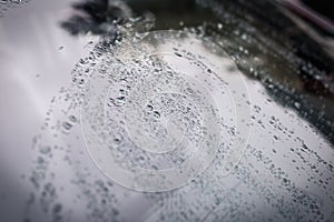 Raindrops on the car glass.