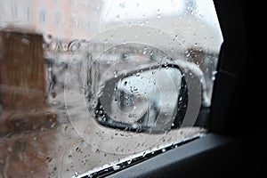 Raindrops on the car rear view mirror