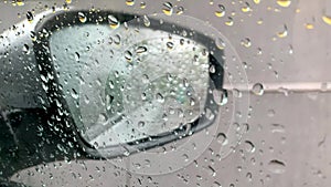 Raindrops on car`s window on raining day.