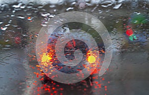 Raindrops on a car window with blurred background