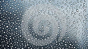 raindrops on car window.water drops background.weather gray background. Rain gray clouds glass texture