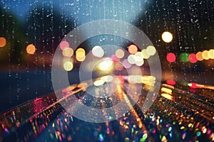 raindrops on a car windshield with bokeh lights