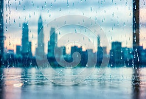 Raindrops clinging to a windowpane, creating a blurred and dreamlike view of the city skyline, offering a moment of