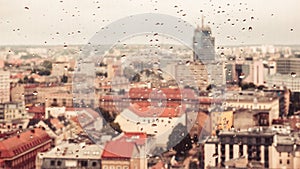 Raindrops on the dirty glass, behind the glass blurred panorama