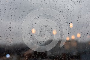 Raindrops downpour on the window, bad weather. Background backdrop, large drops of water on the glass