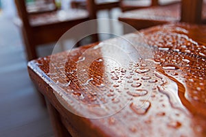 Raindrops drops over a wooden chair