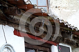 Raindrops falling from a roof in Saint-Cirq-Lapopie, France