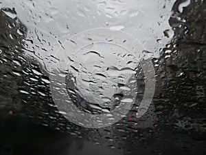 Raindrops forming streaks on a windshield