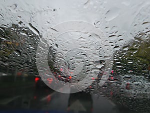 Raindrops forming streaks on a windshield