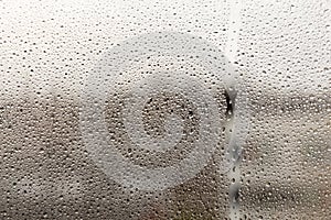 Raindrops on glass on a blurred background. Rain on the window. Dripping rain on the window. Texture.