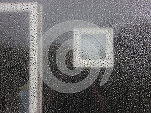 Raindrops on Glass with Dark House Background