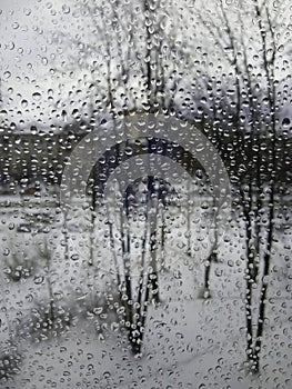 Raindrops on the glass, rain in the new year, rain with snow, wet weather, rainy weather, depression, gray sky