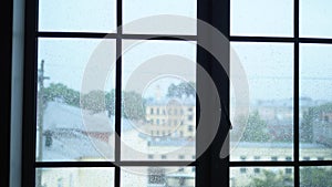 Raindrops on glass window with city view. blur, copy space