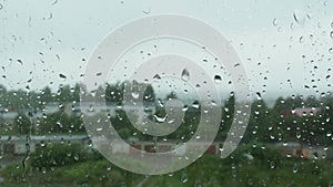 Raindrops on glass window on a rainy day. Wet glass. Raindrops on the glass window on a rainy day. Blurred