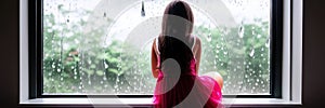 Raindrops like tears. Sad lonely latina girl sit on windowsill in melancholic mood watch rain outside feeling stress