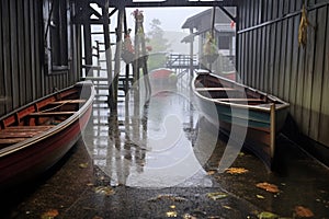 raindrops on rowboats at dock on a rainy day