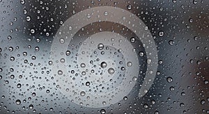 Raindrops are scattered across a glass
