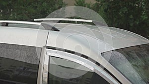 Raindrops on a silver car closeup