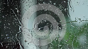 Raindrops splash on the windshield on a rainy day