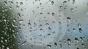 Raindrops splash on the windshield on a rainy day