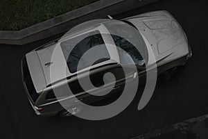 Raindrops on sunroof of grey car. Modern gray SUV CROSSOVER car roof above top drone view on the wet street. after rain. rainy photo