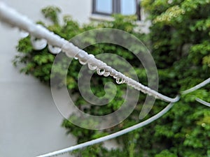 Raindrops on a washing line of a house