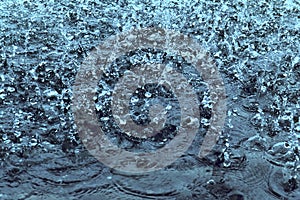 Raindrops on water as background