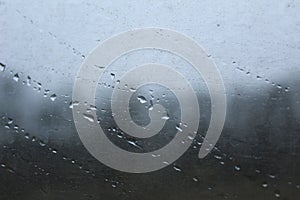 Raindrops or water on the glass on the light blue background copy space