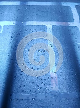 Raindrops wet the fence cover