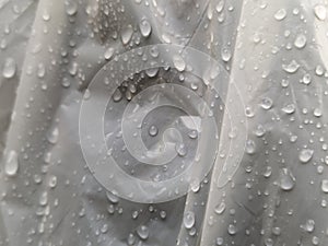 Raindrops on white plastic surface texture background.