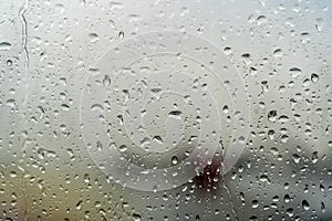Raindrops on the window. Drops of condensation water and wet on the glass background. Rainy cloudy weather, sad mood