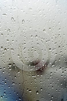 Raindrops on the window. Drops of condensation water and wet on the glass background. Rainy cloudy weather, sad mood